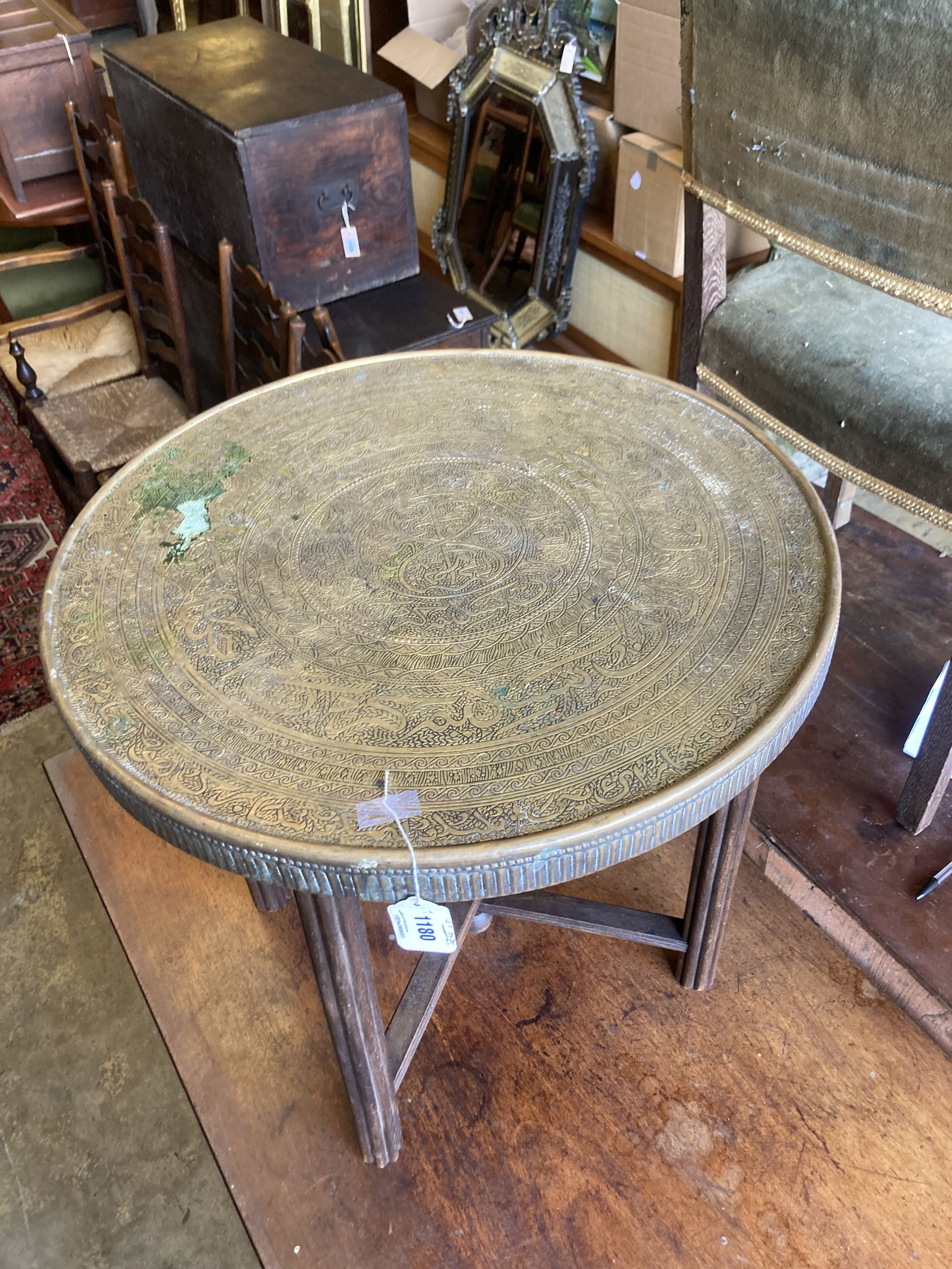 A Benares circular brass tray top occasional table, diameter 59cm, height 58cm Diam.60cm